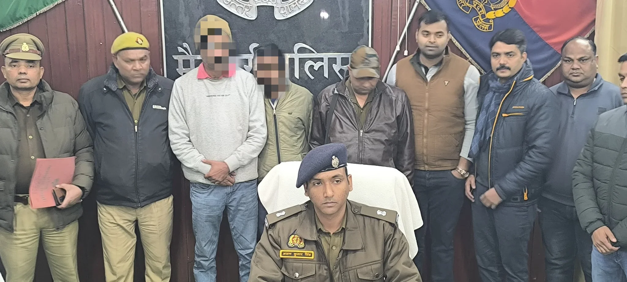 Police officials with detained suspects.